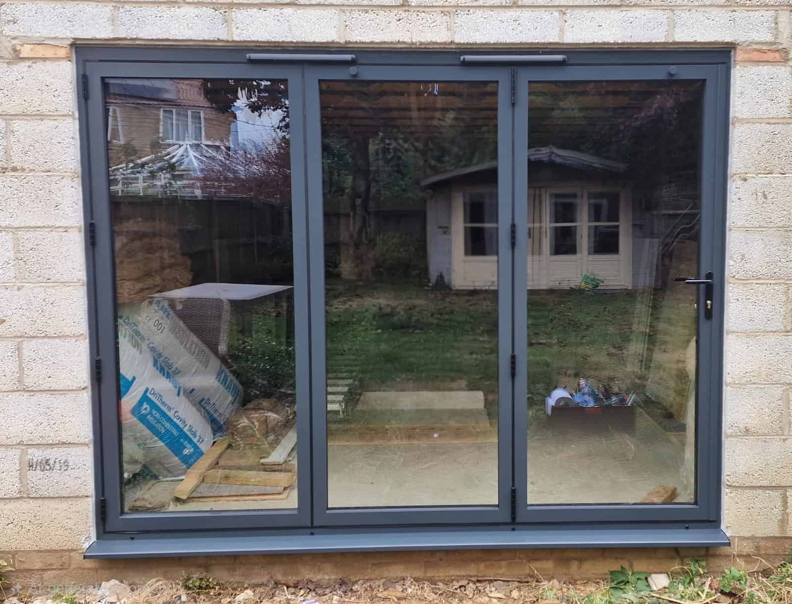 Anthracite grey three-panel glazed replacement doors fitted to a home in Ely.