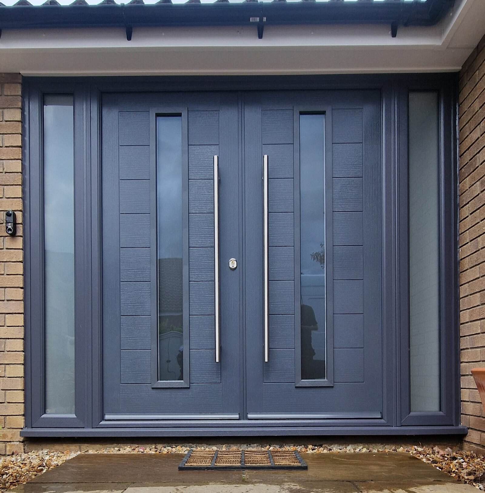 Modern anthracite grey double replacement entrance doors with glazed side panels in Ely.