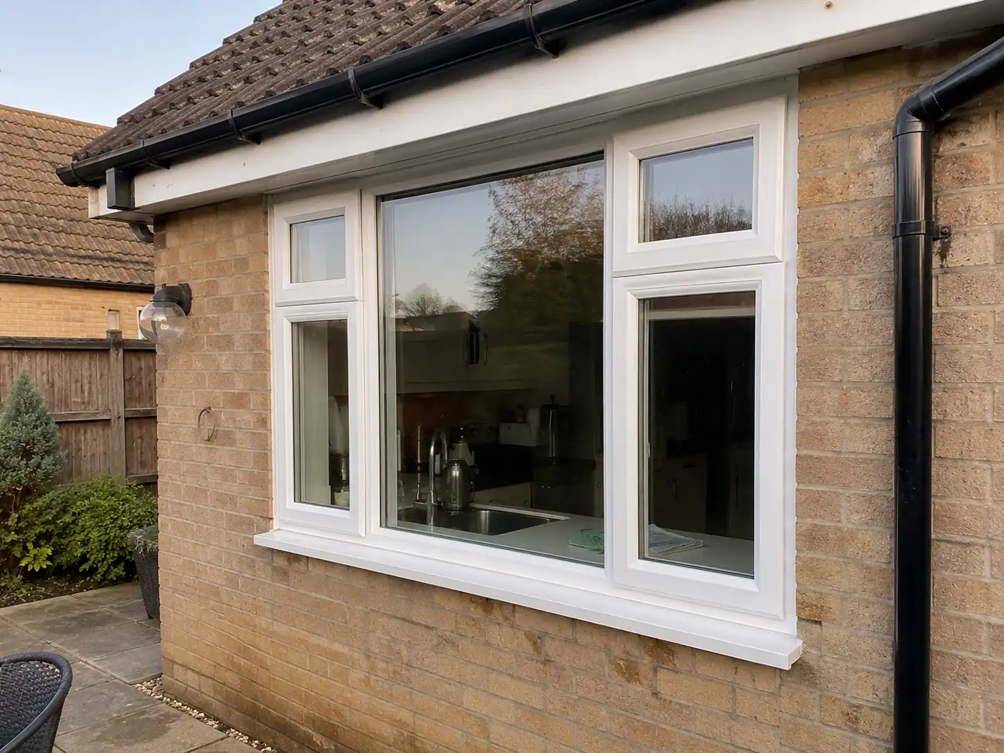 Exterior view of white uPVC windows at an Ely home where secondary glazing has been installed internally.