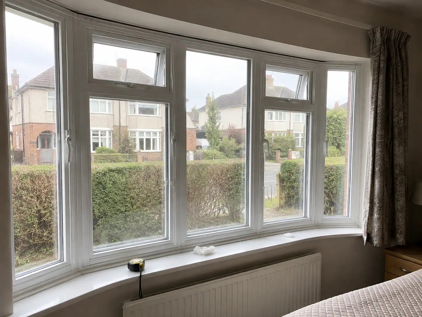 Secondary glazing in Ely fitted to a large white bay window at a residential property.
