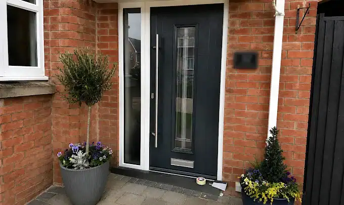 Glass and Glazing in Ely featuring a dark composite front door with a full-height glazed side panel.