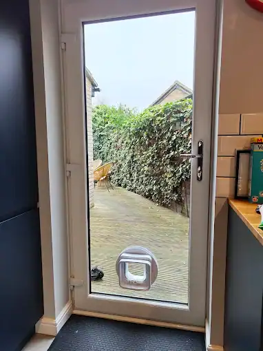 Glass and Glazing in Ely featuring a white framed fully glazed rear door with a fitted pet flap.