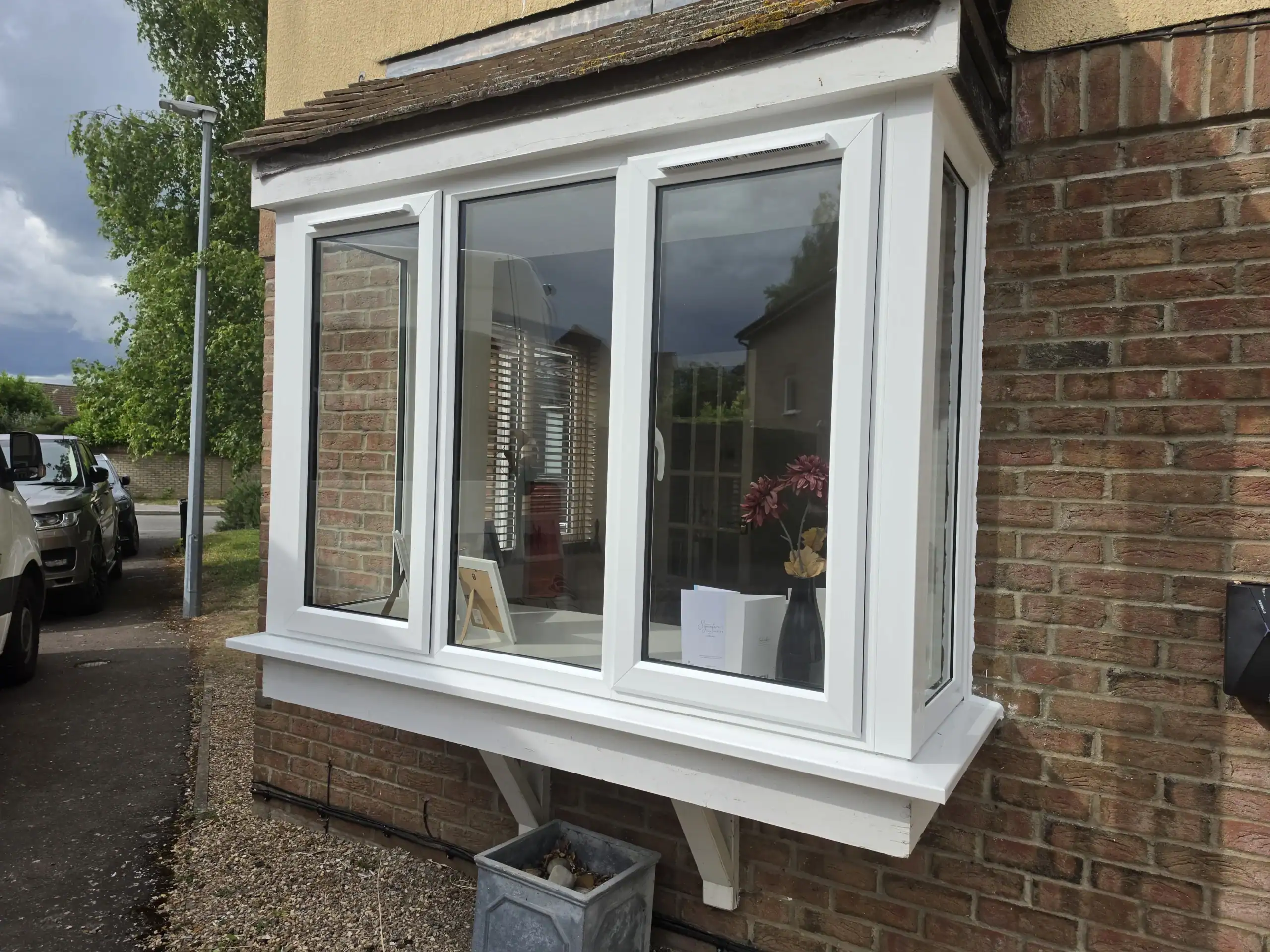 White uPVC windows in Ely fitted to a bay window on a brick-built home.