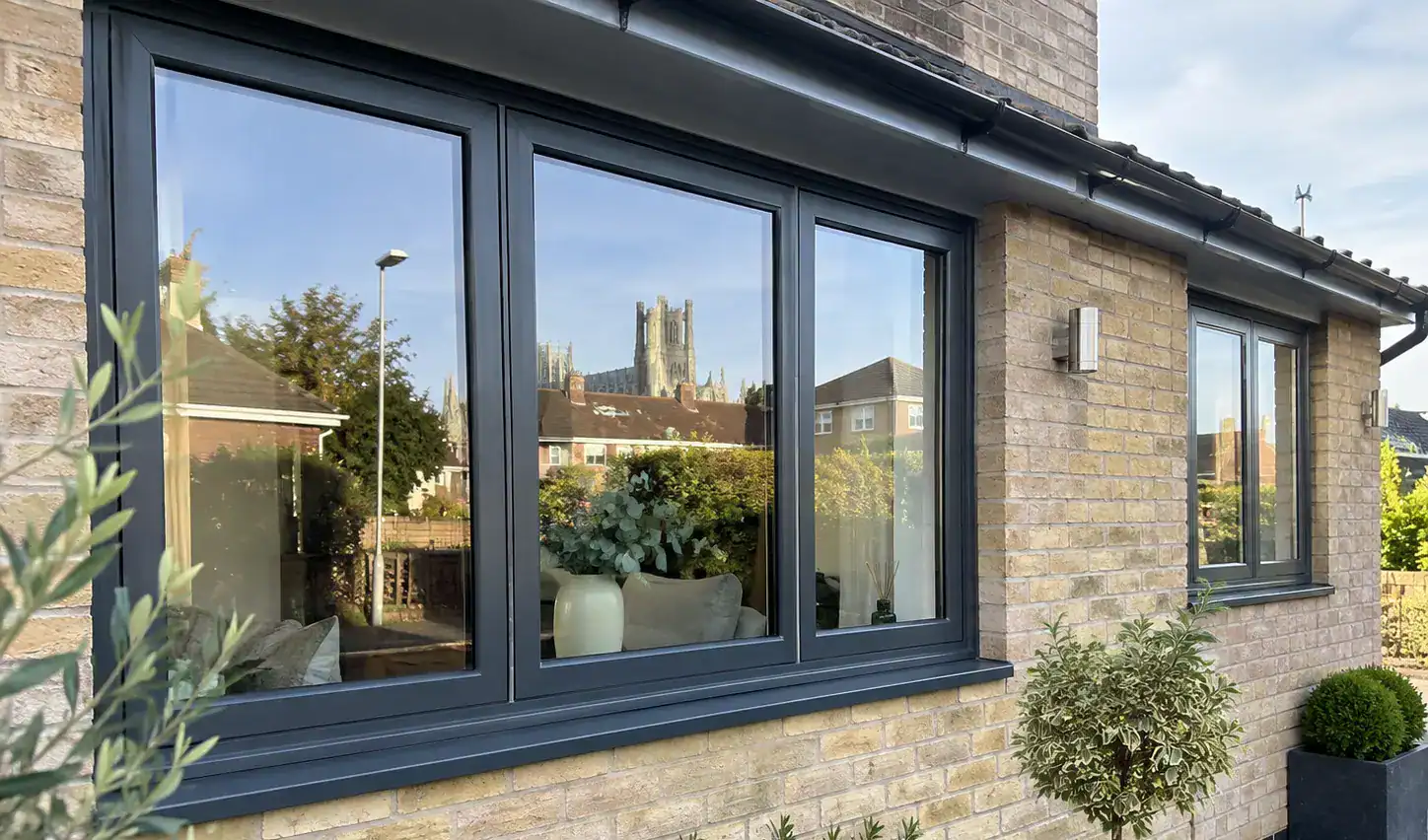 Modern aluminium windows in Ely with anthracite frames on a brick home